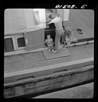 [Untitled photo, possibly related to: This barge wife is "painting" up the ship. Erie Canal, New York]. Sourced from the Library of Congress.