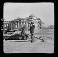 Washington D.C. News photographers making movies. Transplanting a tree on emergency office space construction job. Sourced from the Library of Congress.
