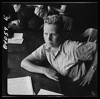 Richwood, West Virginia. A high school boy who is slightly under age is trying to convince the FSA (Farm Security Administration) representative that he should go to New York state to help bring in the harvest. Sourced from the Library of Congress.