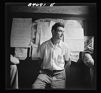 Summersville, West Virginia. A man waiting in courthouse door to sign contract to go to New York state to bring in the crops. Sourced from the Library of Congress.