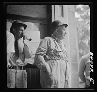 [Untitled photo, possibly related to: Summersville, West Virginia. Cynical citizens watching FSA (Farm Security Administration) official recruiting laborers to bring in the crops in New York state]. Sourced from the Library of Congress.