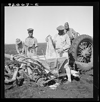 [Untitled photo, possibly related to: Dumping bag of fertilizer into combination bean planter and fertilizer machine used on large farming areas around Lake Okeechobee, Florida]. Sourced from the Library of Congress.
