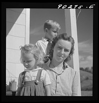 [Untitled photo, possibly related to: Mrs. Howard H. Smith and daughter from Galax by rural home built by FSA (Farm Security Administration) for defense workers near Radford, Virginia]. Sourced from the Library of Congress.