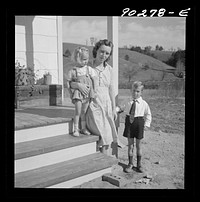 Riner, Virginia. Radford, Virginia (vicinity). Elsie Marie and Howard Jr., children of Mr. Howard H. Smith, with their mother on the porch of their new rural home, which was built for them by the FSA (Farm Security Administration) on J.T Holley's property. Sourced from the Library of Congress.