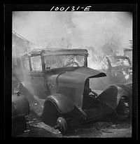 Washington, D.C. Scrap salvage campaign, Victory Program. After saleable parts are removed from old cars, the cars are burned in order to strip them of useless materials and to obtain metal skeleton for scrap. Sourced from the Library of Congress.