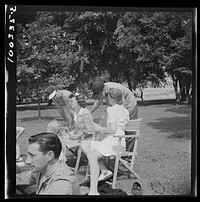 [Untitled photo, possibly related to: Washington, D.C. Audience of wives watching their husbands play amateur baseball on a diamond near Lincoln Memorial on Sunday. Woman in the rear left is keeping score]. Sourced from the Library of Congress.
