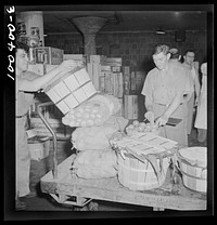 Washington, D.C. District grocery store warehouse on 4th Street S.W. Each store's order is loaded onto a small truck and checked, first by a foreman, again by a checker at the door before being loaded onto a truck. Produce department. Sourced from the Library of Congress.