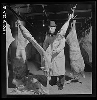 [Untitled photo, possibly related to: Washington, D.C. Quartering beef in the District grocery store warehouse cold room]. Sourced from the Library of Congress.