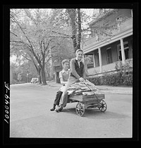 [Untitled photo, possibly related to: Washington, D.C. Salvage drive, Victory Program. Schoolboy volunteers to go from house to home collecting scrap paper]. Sourced from the Library of Congress.