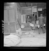 [Untitled photo, possibly related to: Washington, D.C. Scrap salvage campaign, Victory Program. Scrap being weighed before their purchase by retail junk dealer]. Sourced from the Library of Congress.
