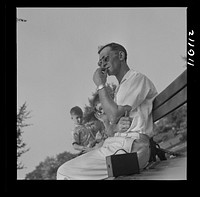 Detroit, Michigan. Worker resting on a park bench in the zoological park. Sourced from the Library of Congress.