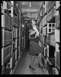 Washington, D.C. Jewal Mazique [i.e. Jewel] working in the stacks of the Library of Congress. Sourced from the Library of Congress.