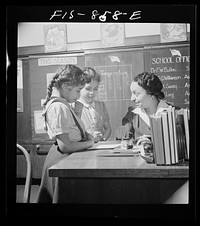 Washington, D.C. Teacher helping pupils in  grammar school. Sourced from the Library of Congress.
