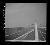 Parris Island, South Carolina. U.S. Marine Corps glider detachment training camp. An aerial "tug boat" tows three gliders high above the field. Sourced from the Library of Congress.