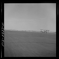 [Untitled photo, possibly related to: Parris Island, South Carolina. An aerial "tug boat" towing three gliders across the field at the U.S. Marine Corps glider detachment training camp]. Sourced from the Library of Congress.