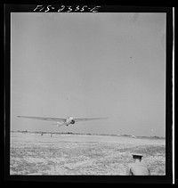 Parris Island, South Carolina. A glider plane being towed over a field at the U.S. Marine Corps glider detachment training camp. Sourced from the Library of Congress.