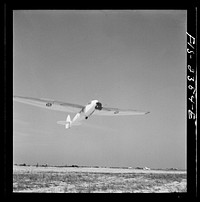[Untitled photo, possibly related to: Parris Island, South Carolina. A glider plane being towed over a field at the U.S. Marine Corps glider detachment training camp]. Sourced from the Library of Congress.
