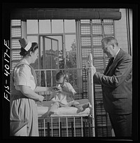 [Untitled photo, possibly related to: Washington, D.C. Mr. Lund, who is head of the District Red Cross, visits the Children's Hospital where General MacArthur's niece is a nurse's aid]. Sourced from the Library of Congress.