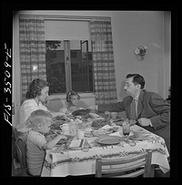 [Untitled photo, possibly related to: Greenbelt, Maryland. Federal housing project. Mr. and Mrs. Leslie Atkins, Ann, and Pierce Atkins having supper]. Sourced from the Library of Congress.