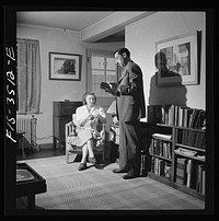 [Untitled photo, possibly related to: Greenbelt, Maryland. Federal housing project. Mr. and Mrs. Leslie Atkins in their living room discussing the seeds they plan to plant this year in their garden]. Sourced from the Library of Congress.