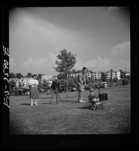 [Untitled photo, possibly related to: Greenbelt, Maryland. Parents taking baby's picture on Sunday]. Sourced from the Library of Congress.