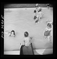 [Untitled photo, possibly related to: Greenbelt, Maryland. A constant stream of water runs down the swimming pool slide]. Sourced from the Library of Congress.