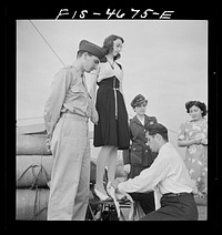 [Untitled photo, possibly related to: Washington, D.C. Bandaging an "injured" arm as part of a course in first aid, aboard a Potomac River boat]. Sourced from the Library of Congress.