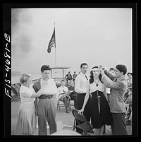 [Untitled photo, possibly related to: Washington, D.C. Bandaging an "injured" arm as part of a course in first aid, aboard a Potomac River boat]. Sourced from the Library of Congress.