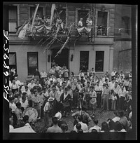 [Untitled photo, possibly related to: New York, New York. Dancing and music on Mott Street at a flag raising ceremony in honor of neighborhood boys in the United States Army]. Sourced from the Library of Congress.