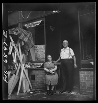 New York, New York. Shoemaker and his wife in the Italian section on Mott Street. Was images in honor of the feast of San Rocco at right. Sourced from the Library of Congress.