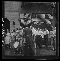 [Untitled photo, possibly related to: New York, New York. Italian-Americans in the rain watching a flag raising ceremony in honor of the feast of San Rocco at right]. Sourced from the Library of Congress.