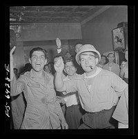 [Untitled photo, possibly related to: New York, New York. Brooklyn band of Italian-Americans, after playing at Mott Street flag raising ceremony in honor of neighborhood boys in the United States Army, retiring to a neighborhood bar out of the rain]. Sourced from the Library of Congress.
