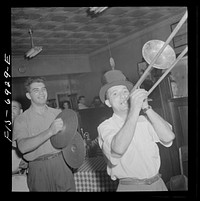 [Untitled photo, possibly related to: New York, New York. Brooklyn band of Italian-Americans, after playing at Mott Street flag raising ceremony in honor of neighborhood boys in the United States Army, retiring to a neighborhood bar out of the rain]. Sourced from the Library of Congress.