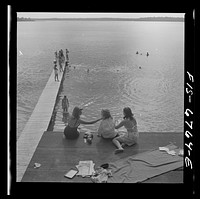 Interlochen, Michigan. National music camp where 300 or more young musicians study symphonic music for eight weeks each summer. Long shot showing swimming and the diving raft. Sourced from the Library of Congress.