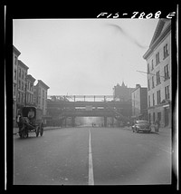 [Untitled photo, possibly related to: New York, New York. Second Avenue elevated railway at 14th Street, in process of demolition; looking east at 7 a.m.]. Sourced from the Library of Congress.
