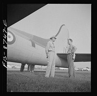 [Untitled photo, possibly related to: Wayne County Airport, a United States Army Air Corps air ferry command base sixteen miles from Detroit, Michigan. Workers inspecting a plane]. Sourced from the Library of Congress.