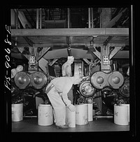 Pressroom of the New York Times newspaper. Numbering cast plates with page numbers for identification. Sourced from the Library of Congress.