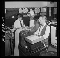 New York, New York. New York Times newspaper syndicate. Correspondents of American newspapers which are syndicate members. In background, copy boy posts Times dispatches. Sourced from the Library of Congress.