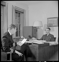 Washington, D.C. The Australian Legation. Mr Casey, minister from Australia, conferring with the naval attache. Sourced from the Library of Congress.