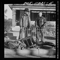Lititz (vicinity), Pennsylvania. Scrap collection drive. Each household placed its contribution on the sidewalk. It was then picked up by local trucks whose owners had volunteered their services for civilian defense. Mr. Gorton, a locksmith, contributes part of a fence as well as old safes. Sourced from the Library of Congress.