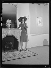 [Untitled photo, possibly related to: Detroit, Michigan. Style show of clothes worn by better-dressed office workers, presented by the Chrysler Girls' Club of the Chrysler Corporation at Saks Fifth Avenue store. Girl admiring a mink coat]. Sourced from the Library of Congress.