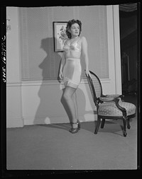 Detroit, Michigan. Fashion show presented by the Chrysler Girls' Club of the Chrysler Corporation at the Saks Fifth Avenue store. Girl modeling a brassiere and girdle. Sourced from the Library of Congress.