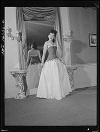 [Untitled photo, possibly related to: Detroit, Michigan. Fashion show presented by the Chrysler Girls' Club of the Chrysler Corporation at Saks Fifth Avenue store. Girl modeling a summer formal grown]. Sourced from the Library of Congress.