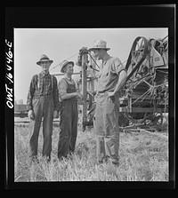 [Untitled photo, possibly related to: Jackson, Michigan. Soldier who was granted a furlough to help with the harvesting on this farm, and farmer watching the threshing]. Sourced from the Library of Congress.