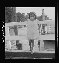 [Untitled photo, possibly related to: Detroit, Michigan. A Venetian night party at the Detroit yacht club, whose members represent the wealthier class of manufacturers and their friends. Little girl at the entrance to the yacht club]. Sourced from the Library of Congress.
