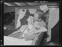 Detroit, Michigan. A Venetian night party at the Detroit yacht club, whose members represent the wealthier class of manufacturers and their friends. Chummy couple in a boat. Sourced from the Library of Congress.