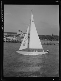 [Untitled photo, possibly related to: Detroit, Michigan. A Venetian night party at the Detroit yacht club, whose members represent the wealthier class of manufacturers and their friends. Sailing boat]. Sourced from the Library of Congress.