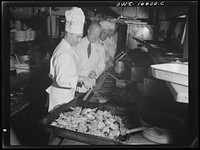 Detroit, Michigan. A Venetian night party at the Detroit yacht club, whose members represent the wealthier class of manufacturers and their friends. Frying chicken. Sourced from the Library of Congress.