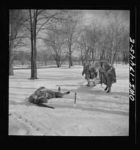 Carlisle, Pennsylvania. Demonstration before Army doctors and officer candidates at the U.S. Army medical field service school. Company aid man has marked this "wounded" man with a tag on his bayonet so he will be picked up by approaching litter bearers. Sourced from the Library of Congress.