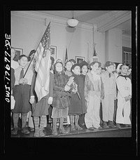 New York, New York students pledging allegiance to the flag in public school eight in an Italian-American section. Sourced from the Library of Congress.